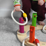 A young child playing with the Bajo Fellow Hoopla Game Set. A traditional style wooden game set that can be used for hoopla and skittles. These heirloom quality toys by Bajo are part of a wide range of wooden toys available here at Babipur.