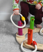 A young child playing with the Bajo Fellow Hoopla Game Set. A traditional style wooden game set that can be used for hoopla and skittles. These heirloom quality toys by Bajo are part of a wide range of wooden toys available here at Babipur.