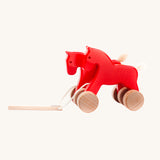Bajo Red Jumping Horses wooden pull along toy. These heirloom quality toys by Bajo are part of a wide range of wooden toys available here at Babipur.