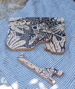 Bajo jungle puzzle with black pattern placed on a able with one of the animal shaped pieces taken out and placed besides it. 