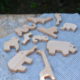 Bajo jungle puzzle animal shaped pieces placed on a table .