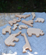 Bajo jungle puzzle animal shaped pieces placed on a table .
