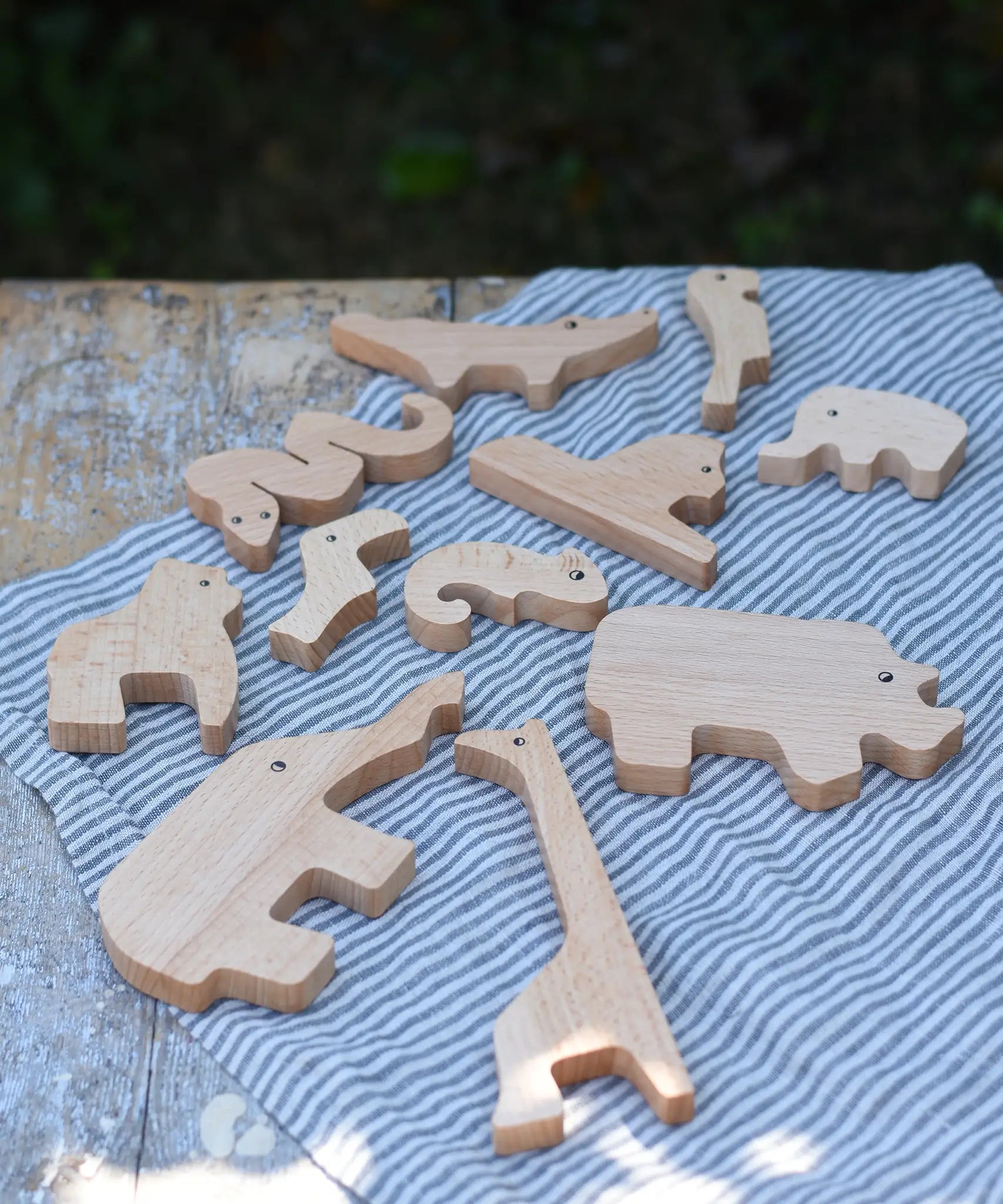 Bajo jungle puzzle animal shaped pieces placed on a table .