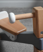 A close up of the handlebar on the Bajo Toys wooden Cycle toddler Ride-On in the monochrome, white and grey colourway. The wooden ride on cycle is part of a wode range of wooden toys available here at Babipur. 