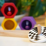 Bajo kids wooden latern spinning top on a white table next to some PlanToys Bee toys