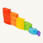Bajo children's toy rainbow blocks set stacked in a curvy line on a white background