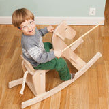 Child riding on the Bajo wooden rocking horse