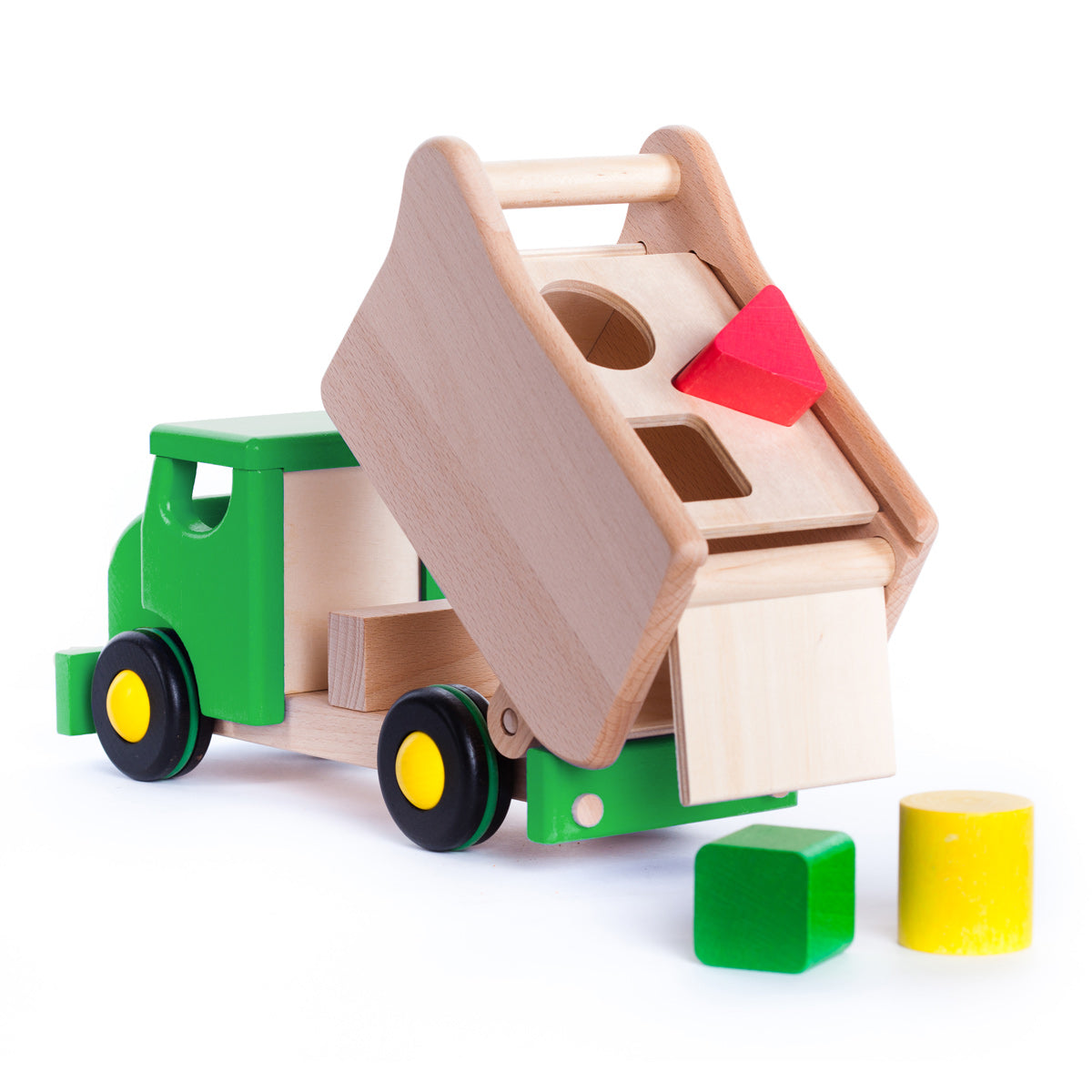 Green Bajo wooden toy lorry with the back tipped up next to some shape blocks on a white background