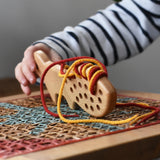 Bajo natural lacing fox in a child's hands in the Babipur playroom.