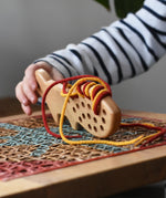 Bajo natural lacing fox in a child's hands in the Babipur playroom.