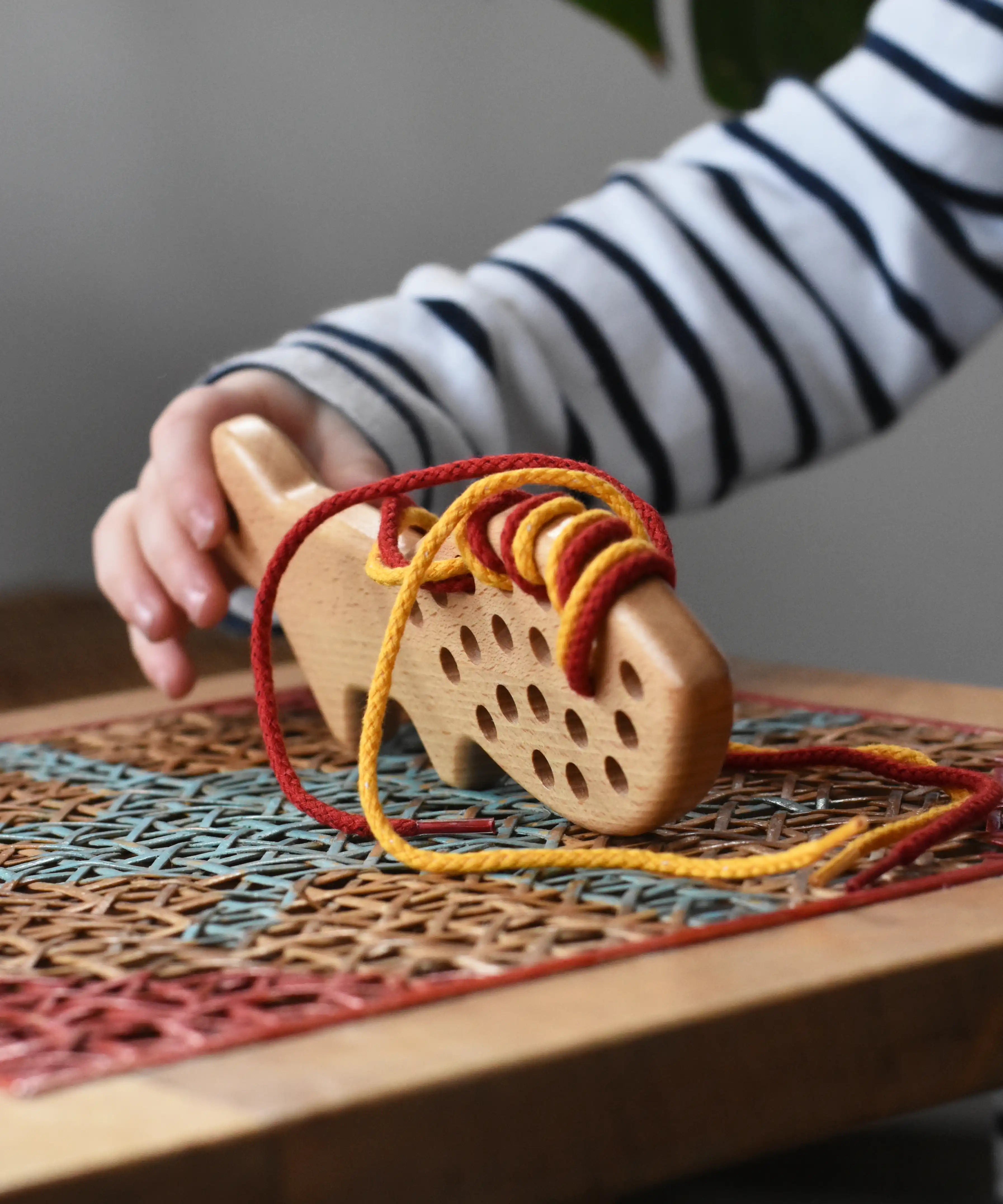 Bajo natural lacing fox in a child's hands in the Babipur playroom.