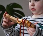 Bajo natural lacing fox in a child's hands in the Babipur playroom.