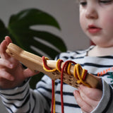 Bajo natural lacing fox in a child's hands in the Babipur playroom.