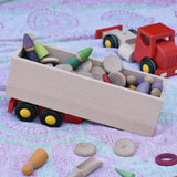 Trailer from the Bajo large truck and trailer wooden toy filled with Grapat number coins and wooden peg dolls. 