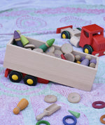 Trailer from the Bajo large truck and trailer wooden toy filled with Grapat number coins and wooden peg dolls. 