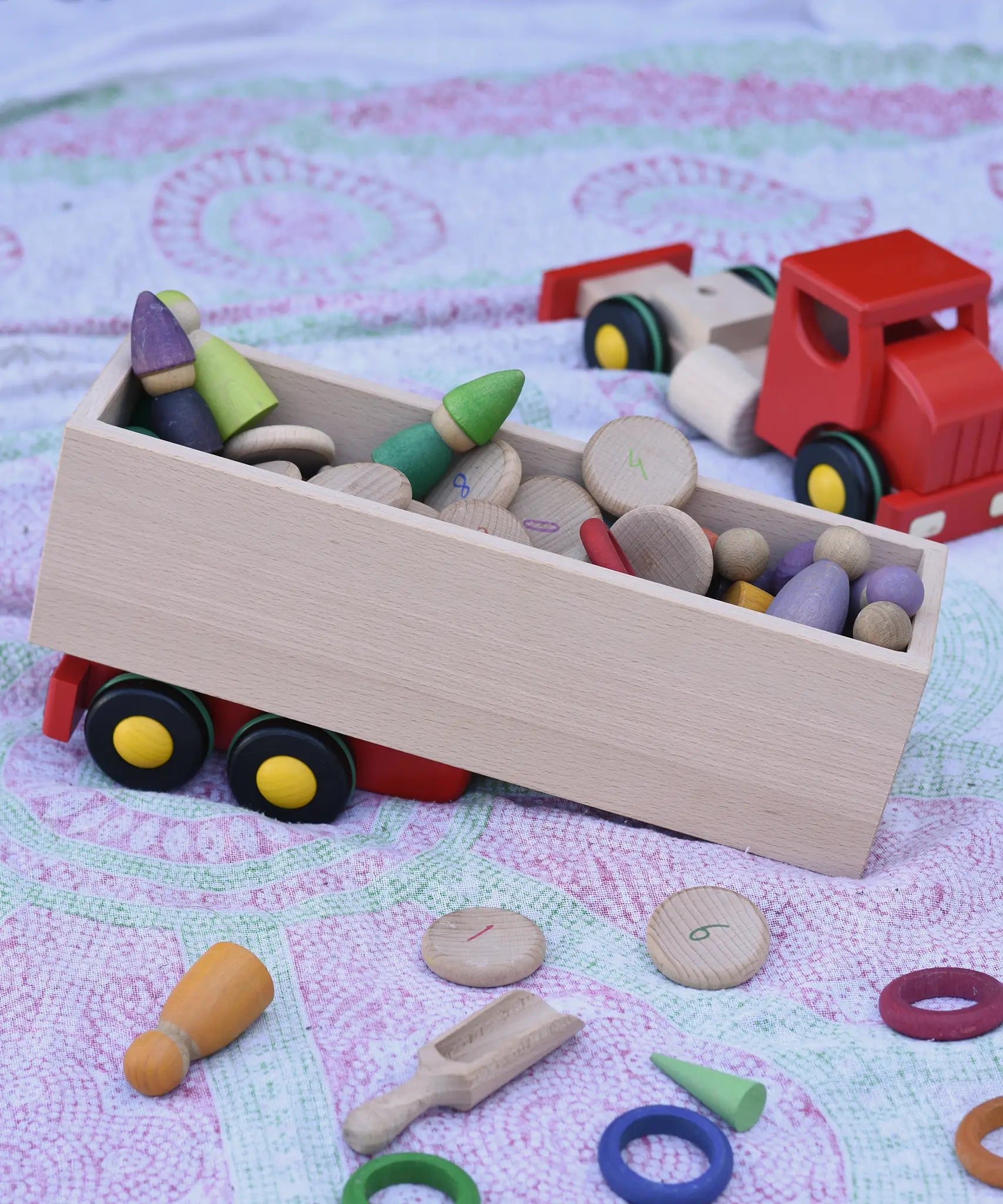 Trailer from the Bajo large truck and trailer wooden toy filled with Grapat number coins and wooden peg dolls. 