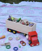 Bajo large truck and trailer wooden toy with trailer filled with Grapat number coins and wooden peg dolls. 