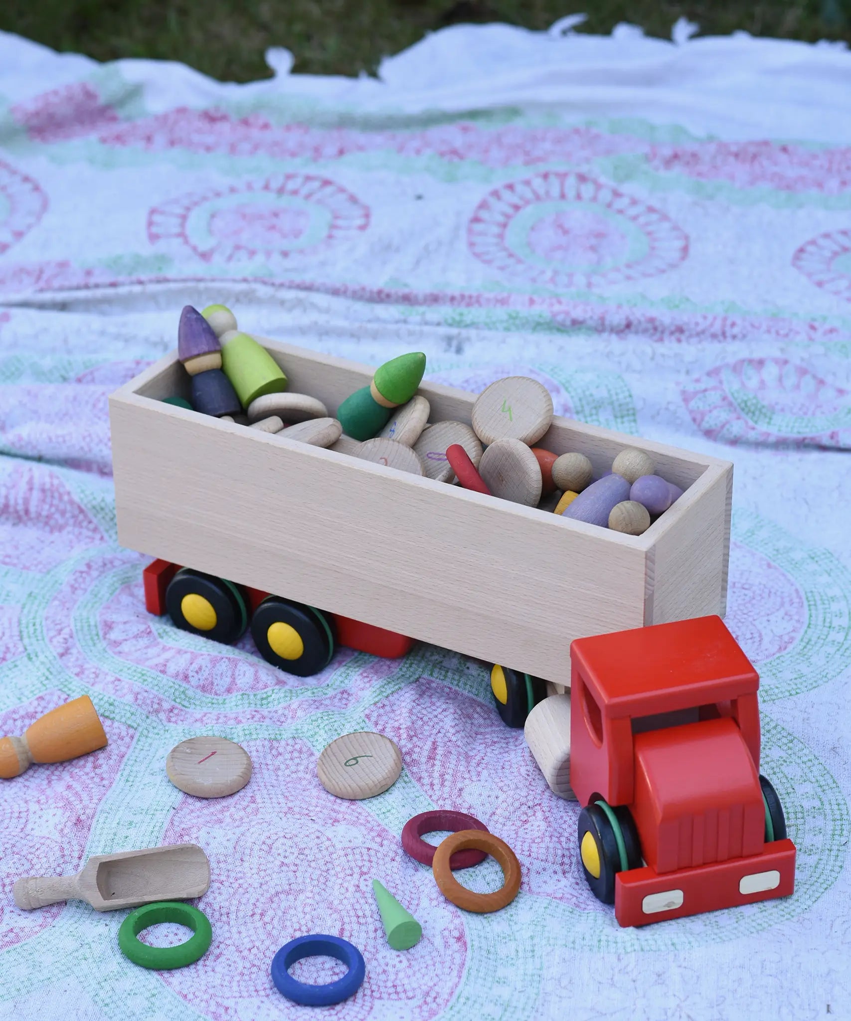 Bajo large truck and trailer wooden toy with trailer filled with Grapat number coins and wooden peg dolls. 