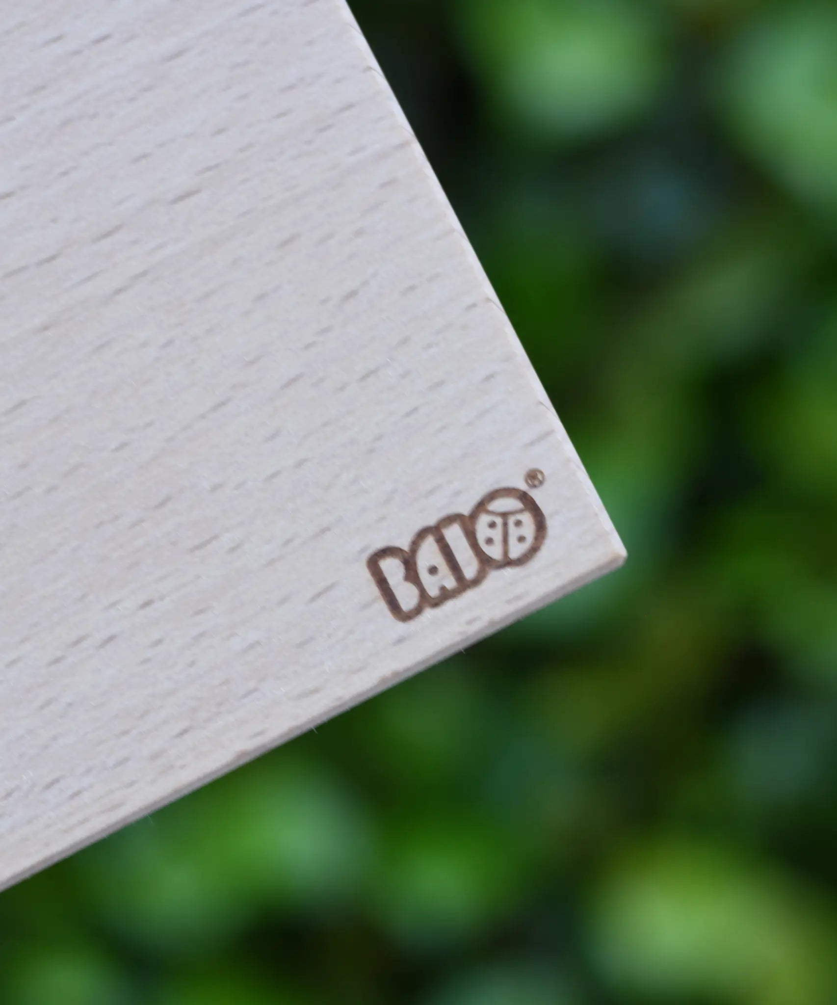 Close up of the logo on the wooden trailer box from the Bajo large truck and trailer wooden toy.