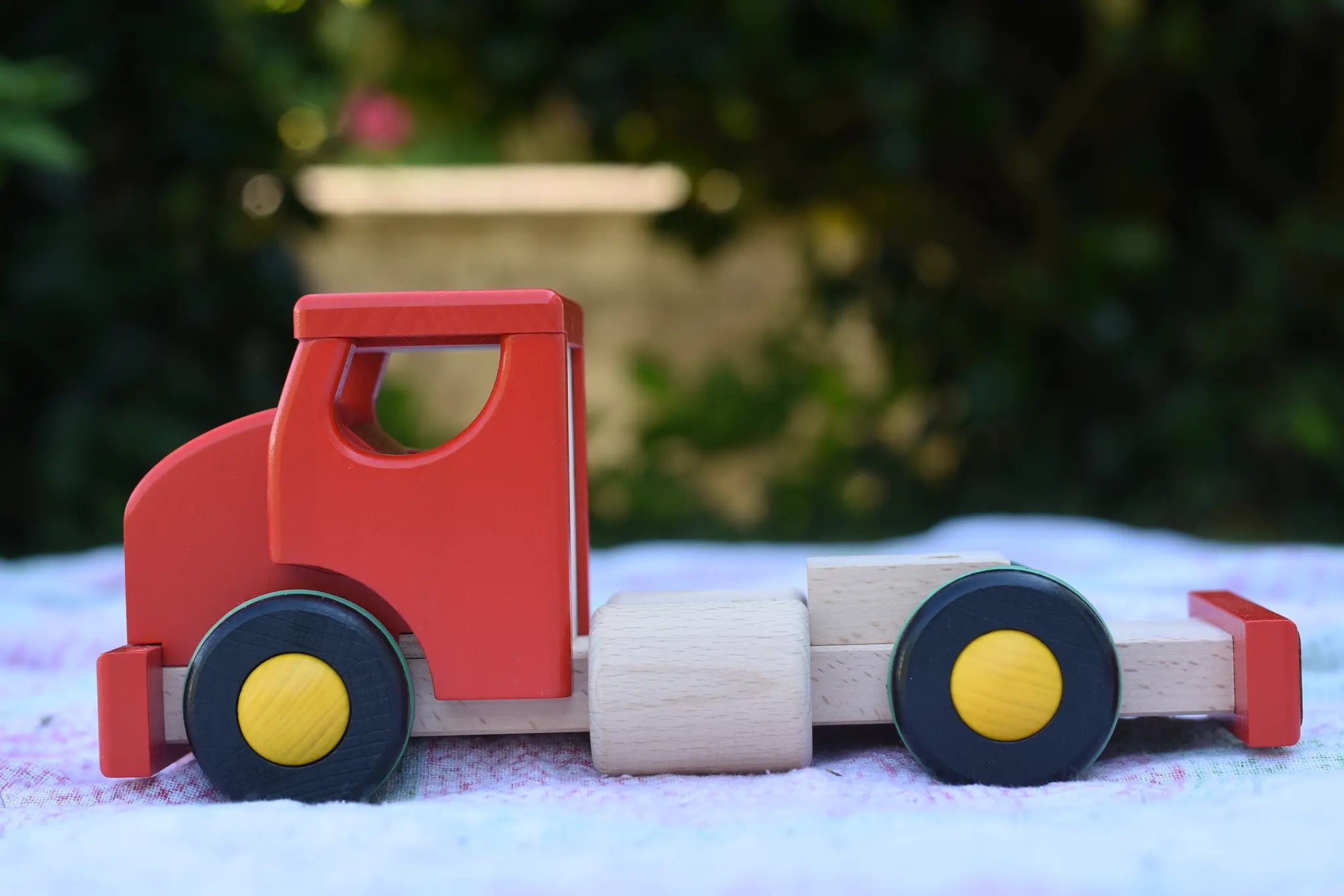 The side of the Bajo large truck and trailer wooden toy shown without the trailer. 
