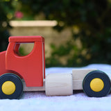 The side of the Bajo large truck and trailer wooden toy shown without the trailer. 