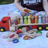 Bajo large truck and trailer wooden toy with lots of Grapat and Grimm's wooden peg dolls placed on the trailer.
