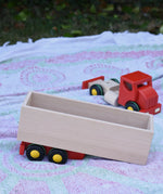  Bajo large truck and trailer wooden toy shown with the trailer separated from the red cab. 