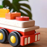 Close up of the back of the Bajo large red cargo truck and wooden shape sorter toy.