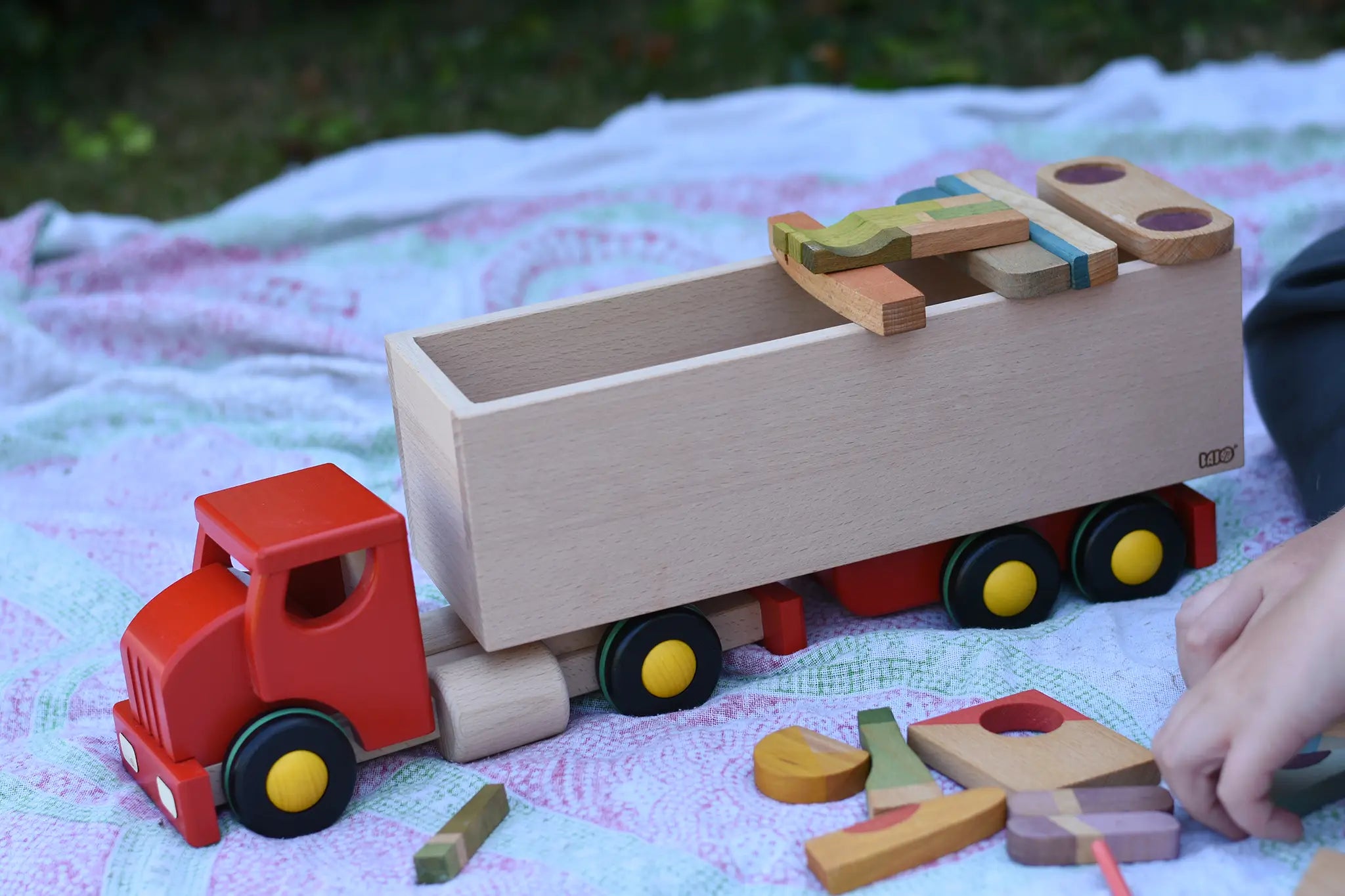 Bajo large truck and trailer wooden toy with loose parts from the Grapat Happy place set balanced on the trailer. 