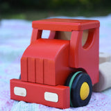 Close up of the front of the red cab from the Bajo large truck and trailer wooden toy. 
