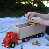 Bajo large truck and trailer wooden toy with loose parts from the Grapat Happy place set balanced on the trailer. 
