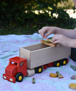 Bajo large truck and trailer wooden toy with loose parts from the Grapat Happy place set balanced on the trailer. 