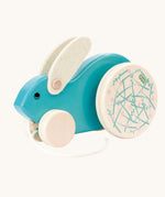 A blue Bajo Big Rabbit toy. This pull along wooden toy has small wheels at the front and large decorated wheels at the back. The rabbit makes a jumping motion as it is being pulled along. We have a wide range of Bajo wooden toys available here at Babipur. 