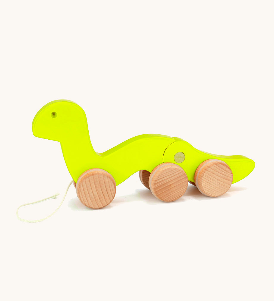 Bajo wooden light green wriggly worm, available at Babipur. Body is in two parts that move up and down and features unpainted wooden wheels with a string on the front to pull along