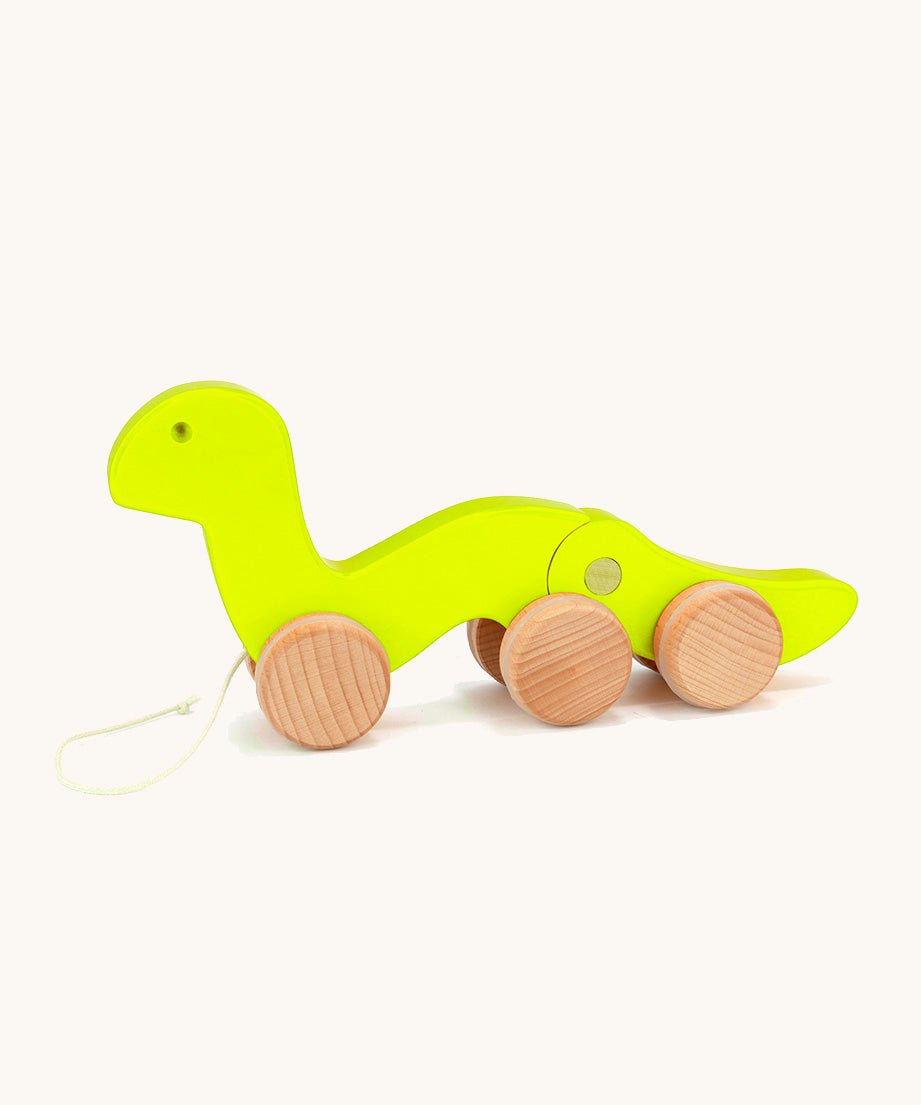 Bajo wooden light green wriggly worm, available at Babipur. Body is in two parts that move up and down and features unpainted wooden wheels with a string on the front to pull along