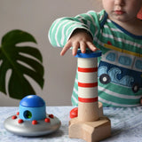 Child playing with the Bajo Lighthouse Stacker.