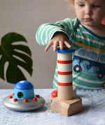 Child playing with the Bajo Lighthouse Stacker.