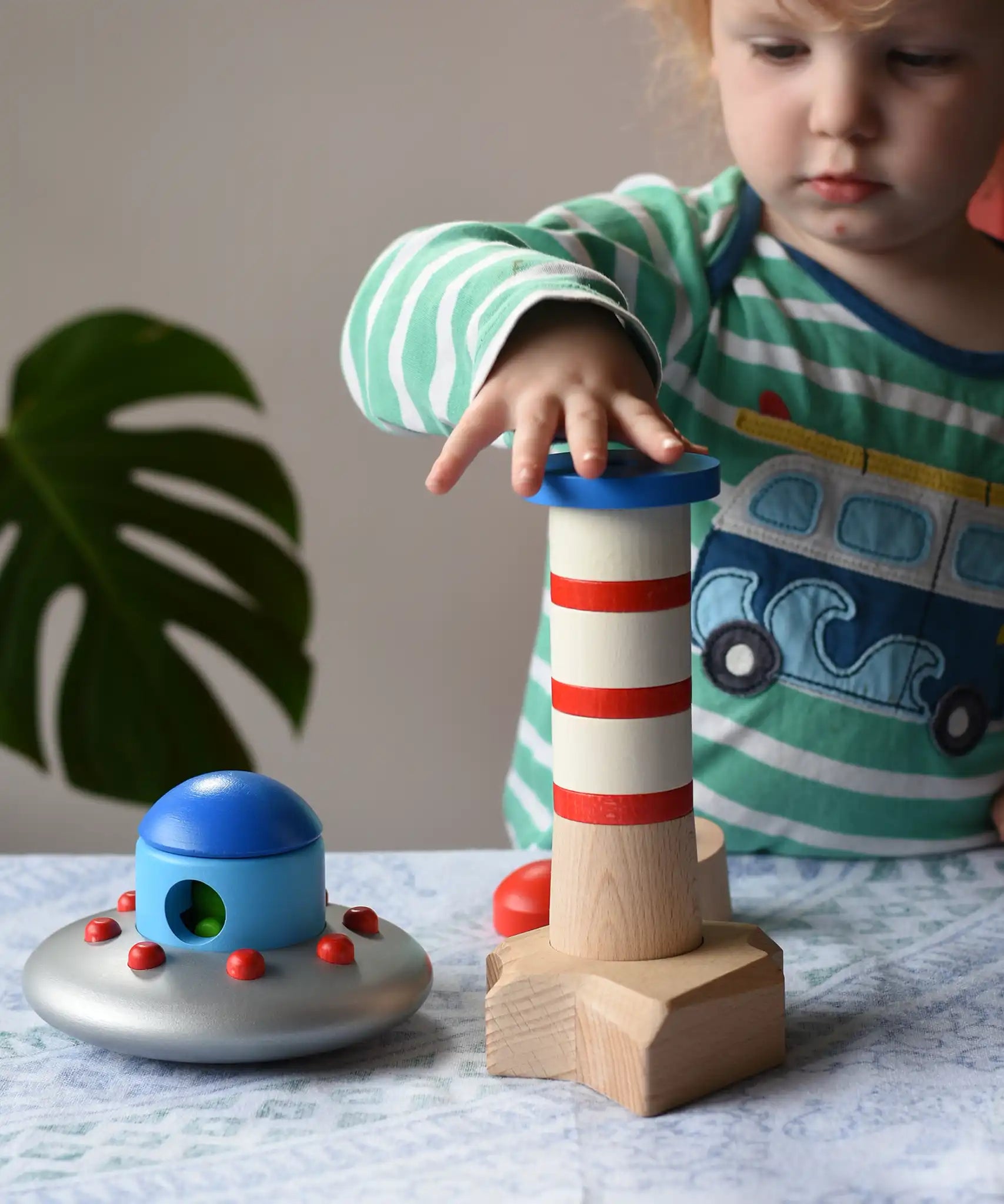 Child playing with the Bajo Lighthouse Stacker.