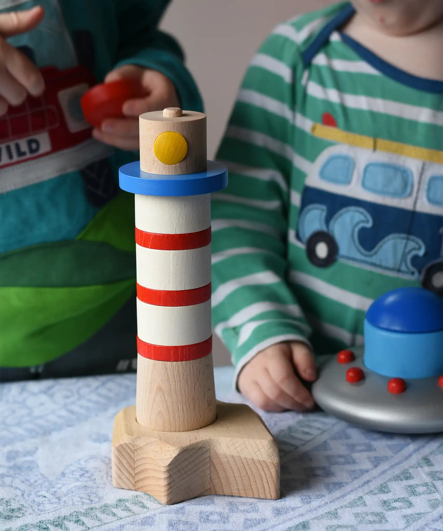 Children playing with the Bajo Lighthouse Stacker.