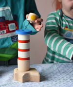 Children playing with the Bajo Lighthouse Stacker.