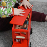 A child playing with the Bajo London bus wooden toy. The child is placing the roof back on the bus. These heirloom quality toys by Bajo are part of a wide range of wooden toys available here at Babipur