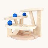The Bajo natural wooden dewdrop ball run. A natural wooden ball run that has 4 levels each with a track carved into them. The ball run comes with three blue coloured wooden balls. These heirloom quality toys by Bajo are part of a wide range of wooden toys available here at Babipur. 