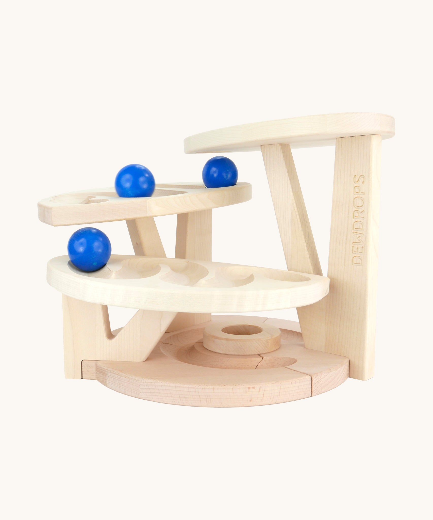 The Bajo natural wooden dewdrop ball run. A natural wooden ball run that has 4 levels each with a track carved into them. The ball run comes with three blue coloured wooden balls. These heirloom quality toys by Bajo are part of a wide range of wooden toys available here at Babipur. 