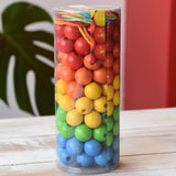 Bajo Mathematical Threading Beads Game in it's packaging placed on a white wooden surface. 