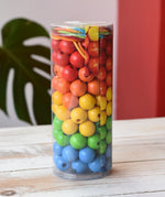 Bajo Mathematical Threading Beads Game in it's packaging placed on a white wooden surface. 
