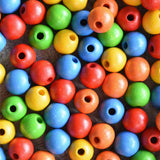 Close up of the  red, orange, yellow, green and blue beads from the Bajo Mathematical Threading Beads Game