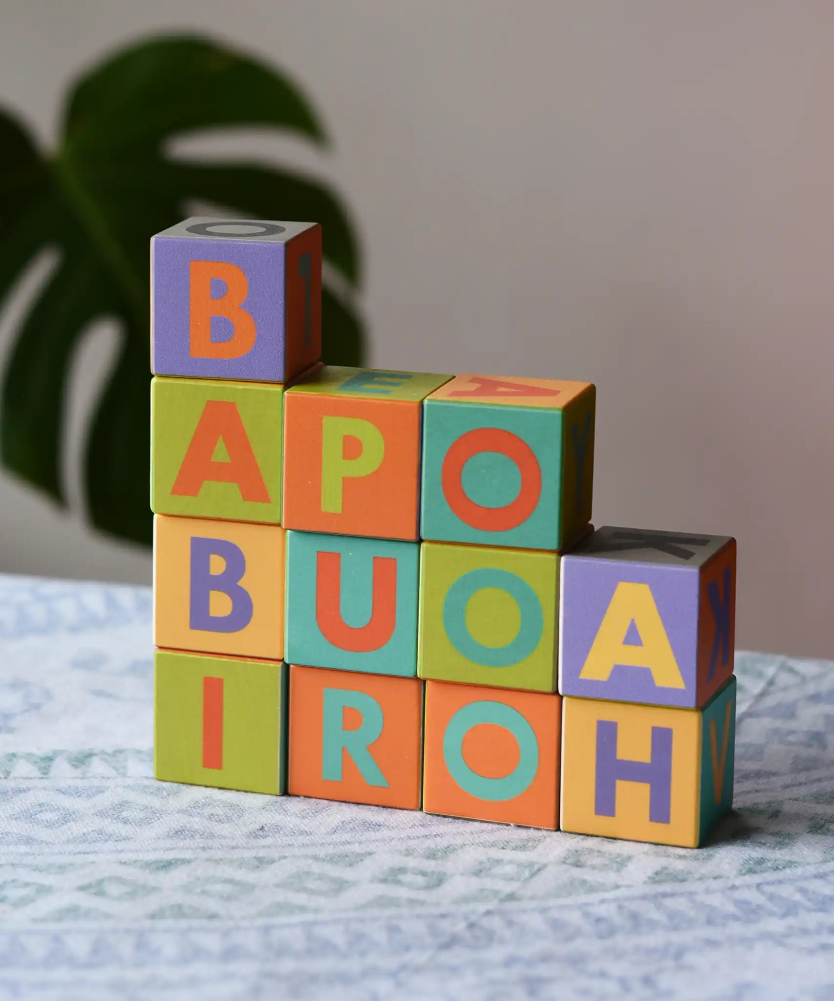 Bajo Me & You Alphabet Blocks stacked up on top of each other. 