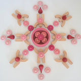 Bajo Mendelsons wooden Balancing Game. The wooden figures from this set have been used with Grapat mandala pieces to create a mandala. 