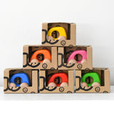 Colorful wooden toy cars in boxes stacked