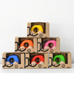 Colorful wooden toy cars in boxes stacked
